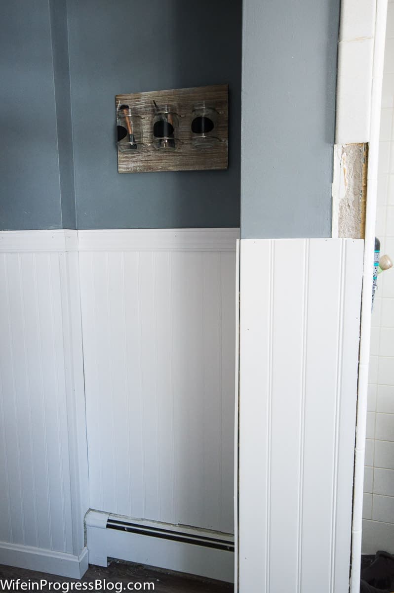 Work in progress - white beadboard being installed over walls damaged by tile removal