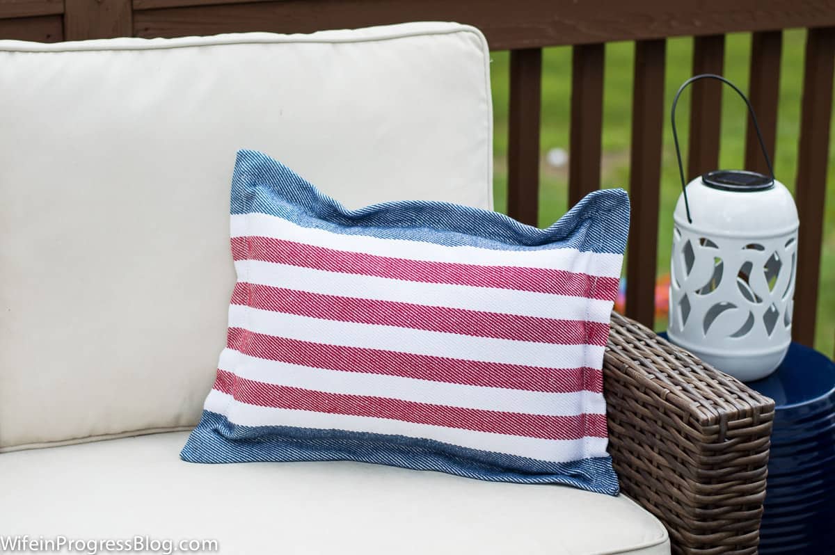 Red, white and blue striped DIY patriotic pillow on cream couch