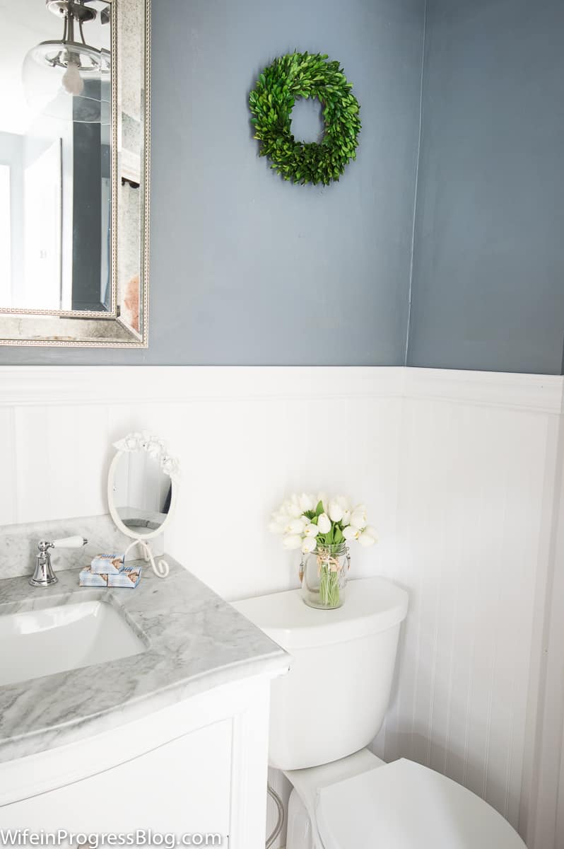 Sherwin Williams Serious Gray bathroom walls with white wainscoting and marble topped vanity