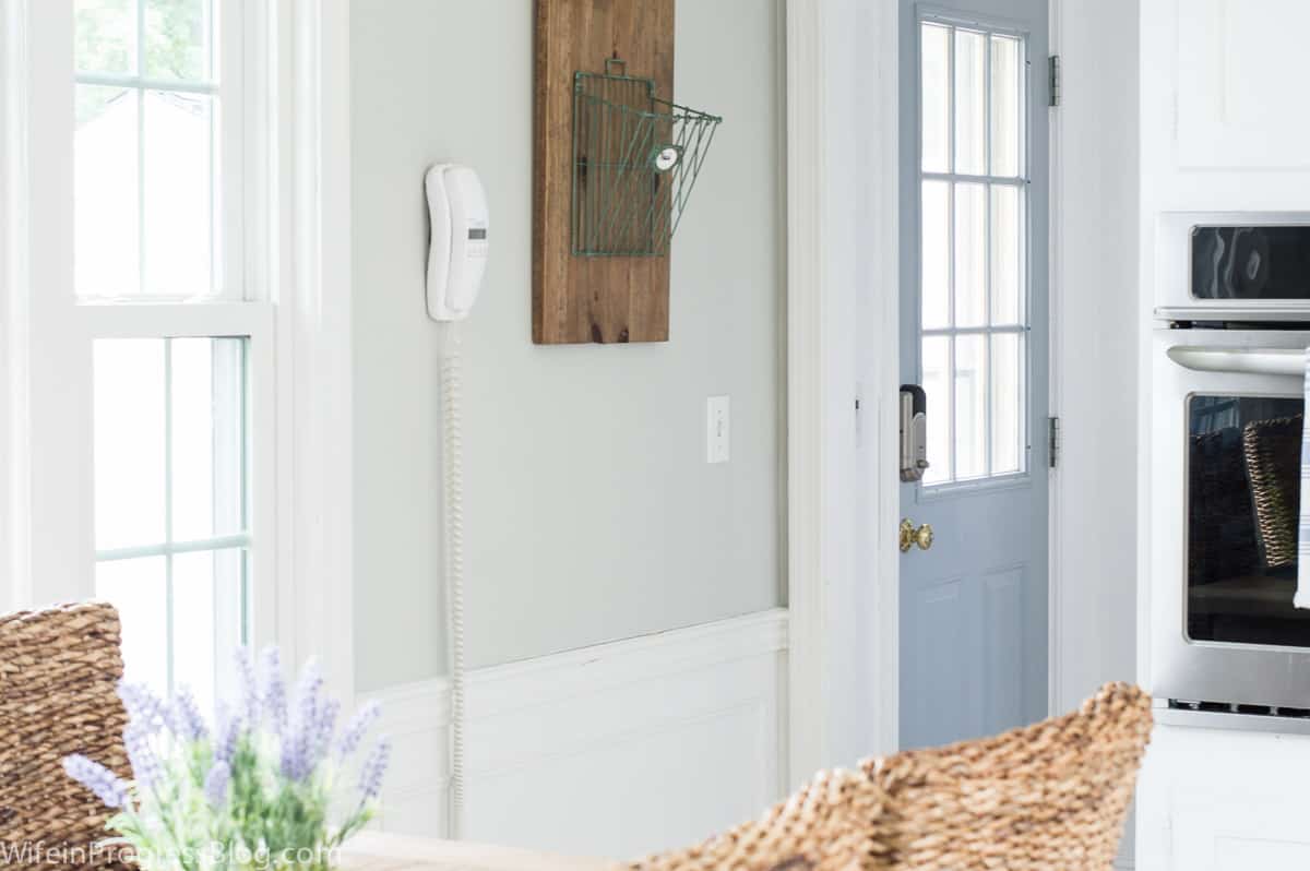 A view of the light blue door leading outside, from the corner of the kitchen