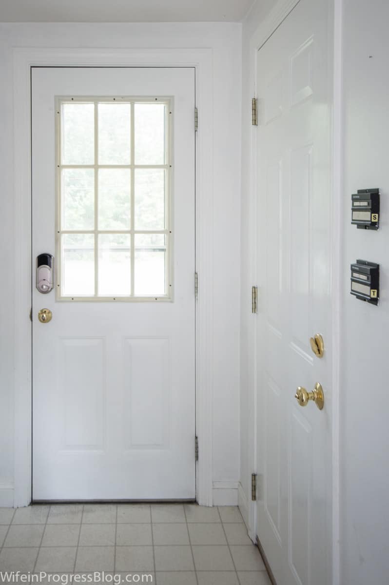 A, door, painted white, with glass panes on the top half, leading outdoors