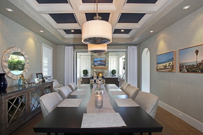 A coffered ceiling with naval inlay ina stunning dinning room.