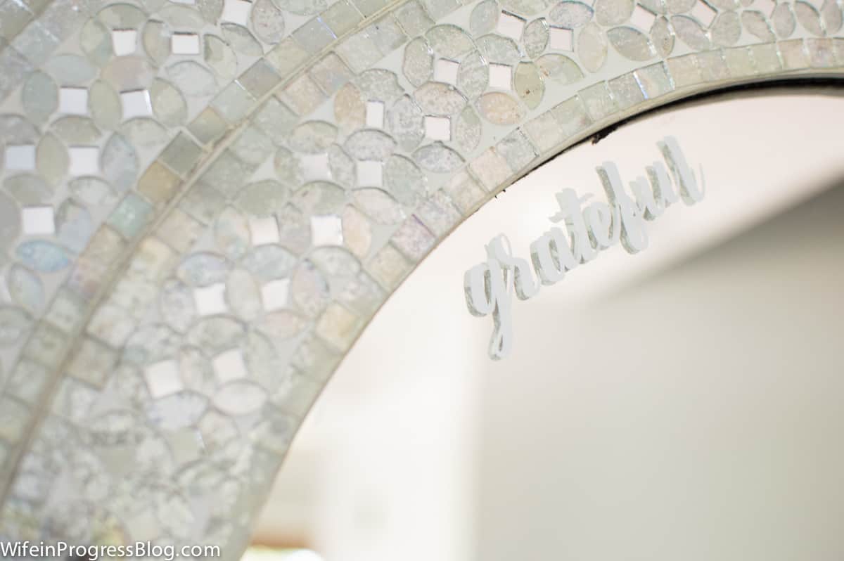 A close-up of the word \'grateful\' made from vinyl stickers on the mirror