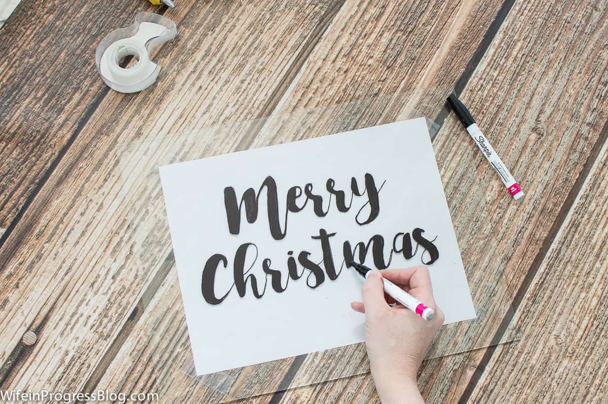 Use Sharpie paint pens to create a farmhouse style Christmas sign