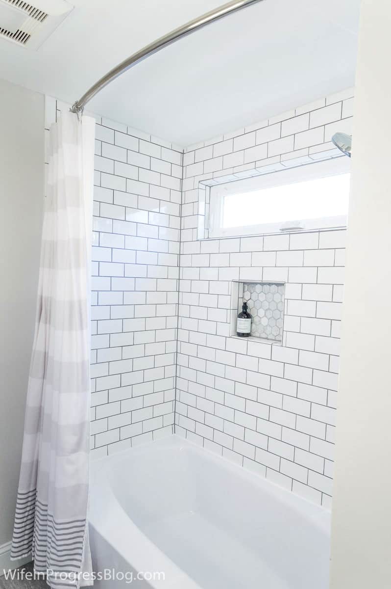 Delorean gray grout on the subway tiles around a freshly-lined bathtub