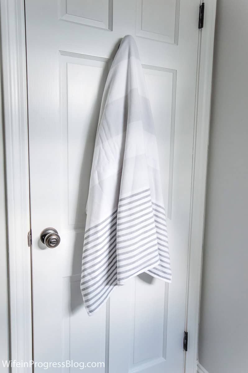 Serena & lily towels hung on main door of bathroom