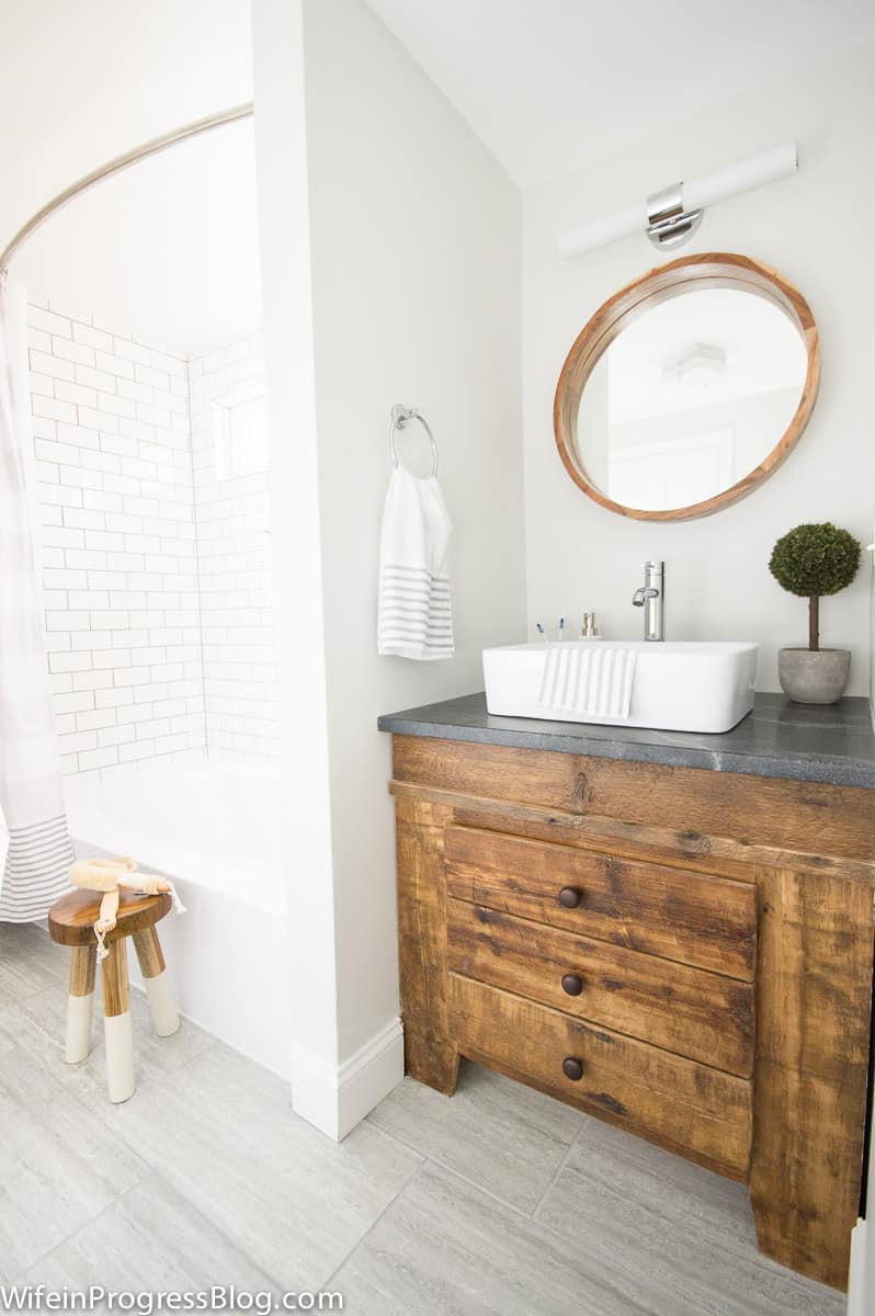 Modern farmhouse bathroom remodel with reclaimed wood vanity. This bathroom used to be completely pink but look at it now!