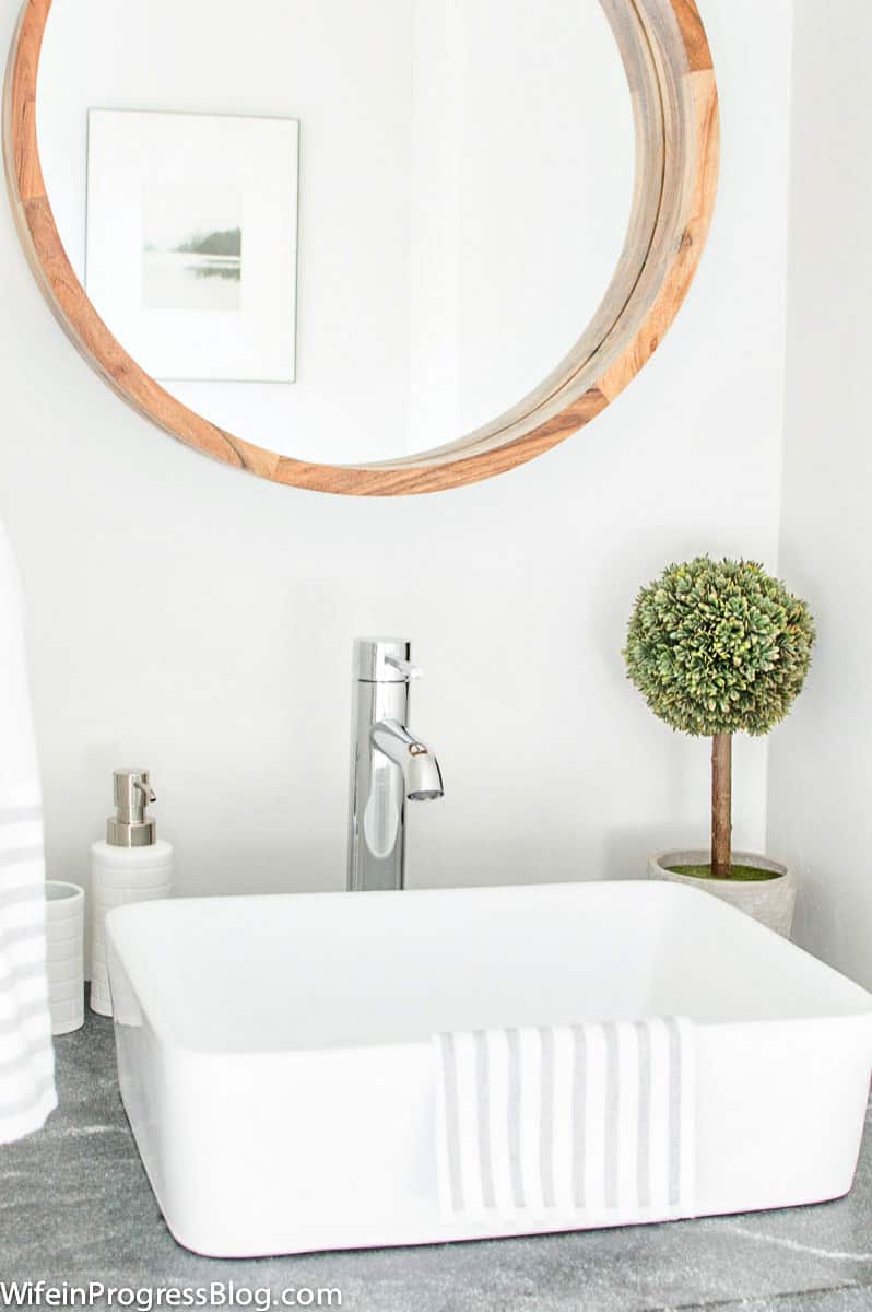 White vessel sink and chrome faucet, installed on granite & reclaimed wood vanity