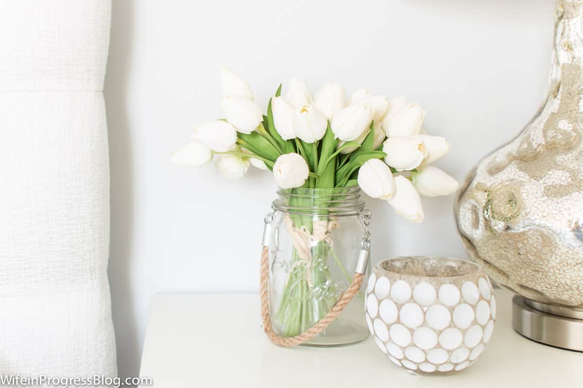 Stonington Gray in a bright bedroom with lots of natural light and fresh flowers on the nightstand