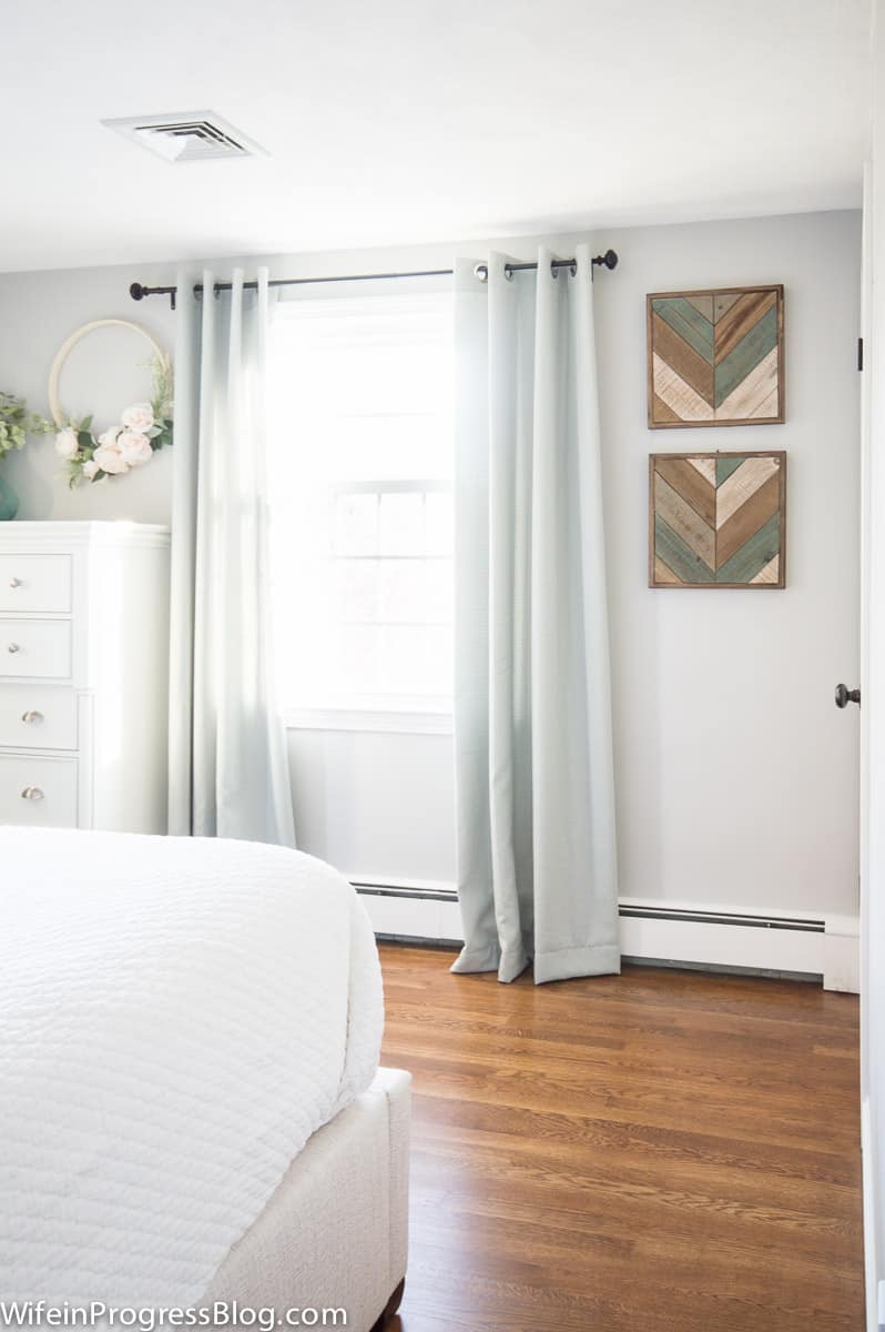 Bedroom with stonington gray walls and light blue curtains.