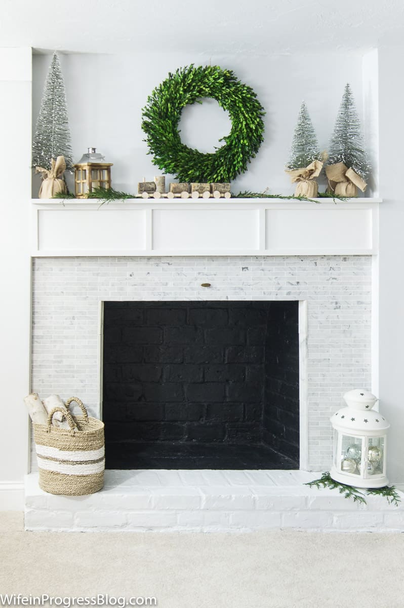 Christmas Decorating Ideas For The Home - add a boxwood wreath and some natural elements to create a farmhouse style Christmas mantel
