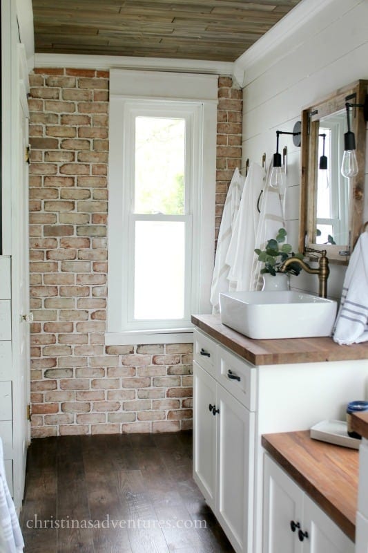 Bathroom with brick veneer walls