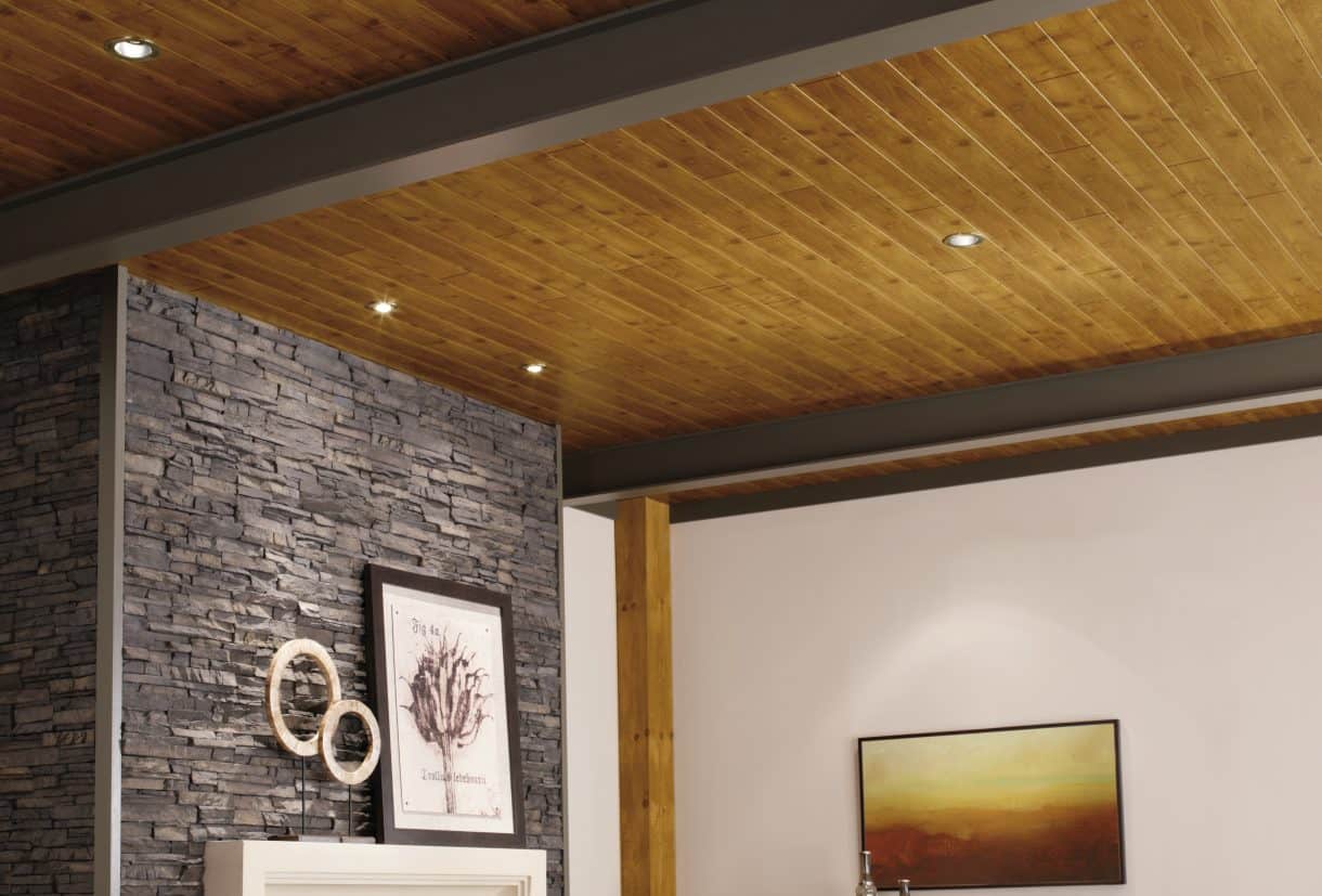 Stained wood planks in natural brown shade, offsetting a grey stone fireplace wall
