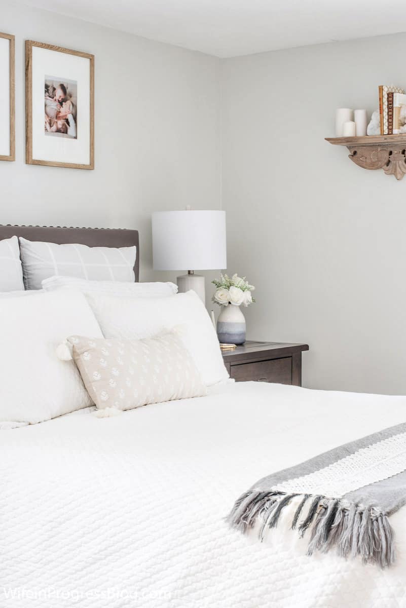 A cohesive color palette of grays, whites and taupes pulls this small master bedroom together and makes it feel bigger than it is.