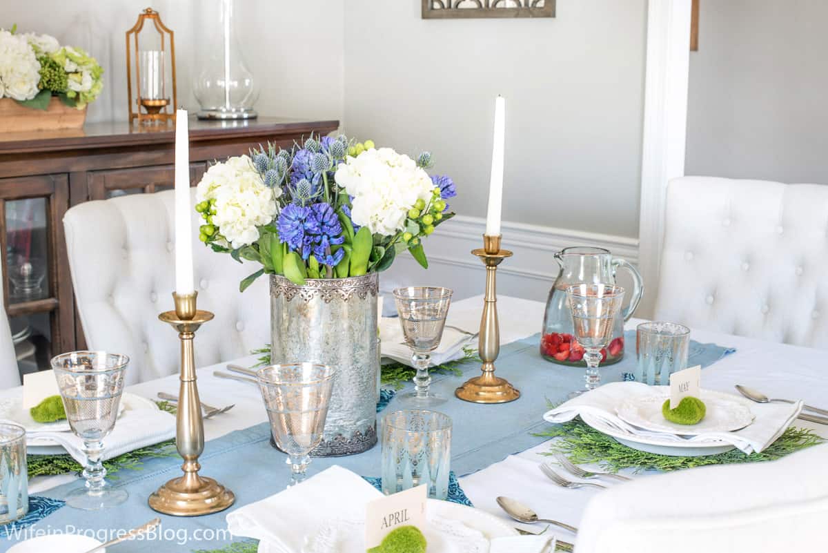 A pretty spring table setting with flowers and pops of green