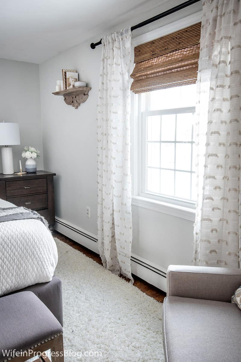 Sheer curtains keep this small master bedroom decor bright and fresh