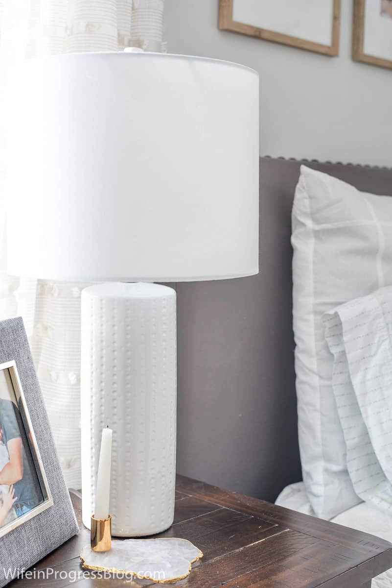 A simple white lamp adorns each nightstand in this small master bedroom makeover