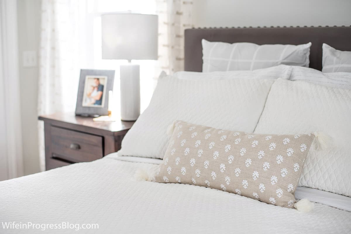 Add texture to the bed to bring interest to a small master bedroom