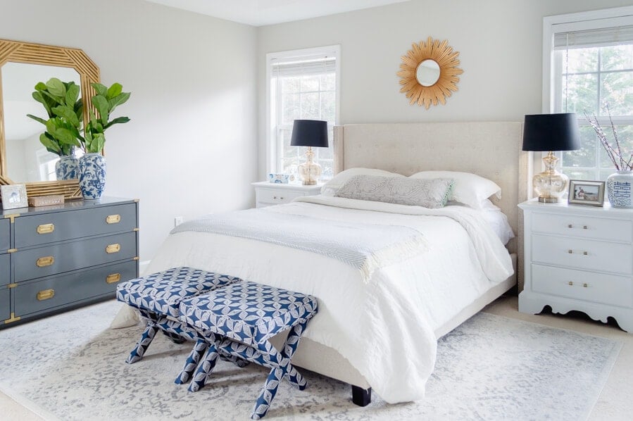 Bedroom painted SW Agreeable Gray with white bedding and blue accents 