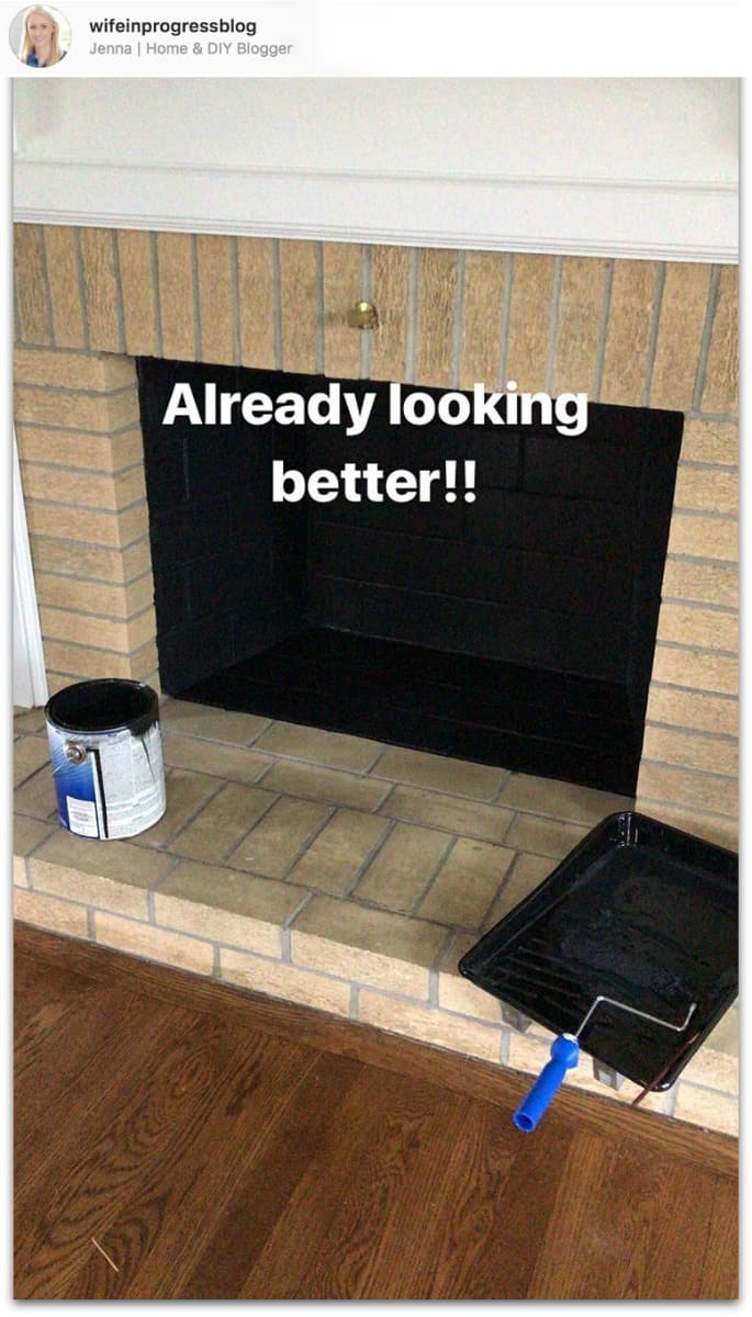 Interior of firebox painted black, with a paint roller and tray nearby