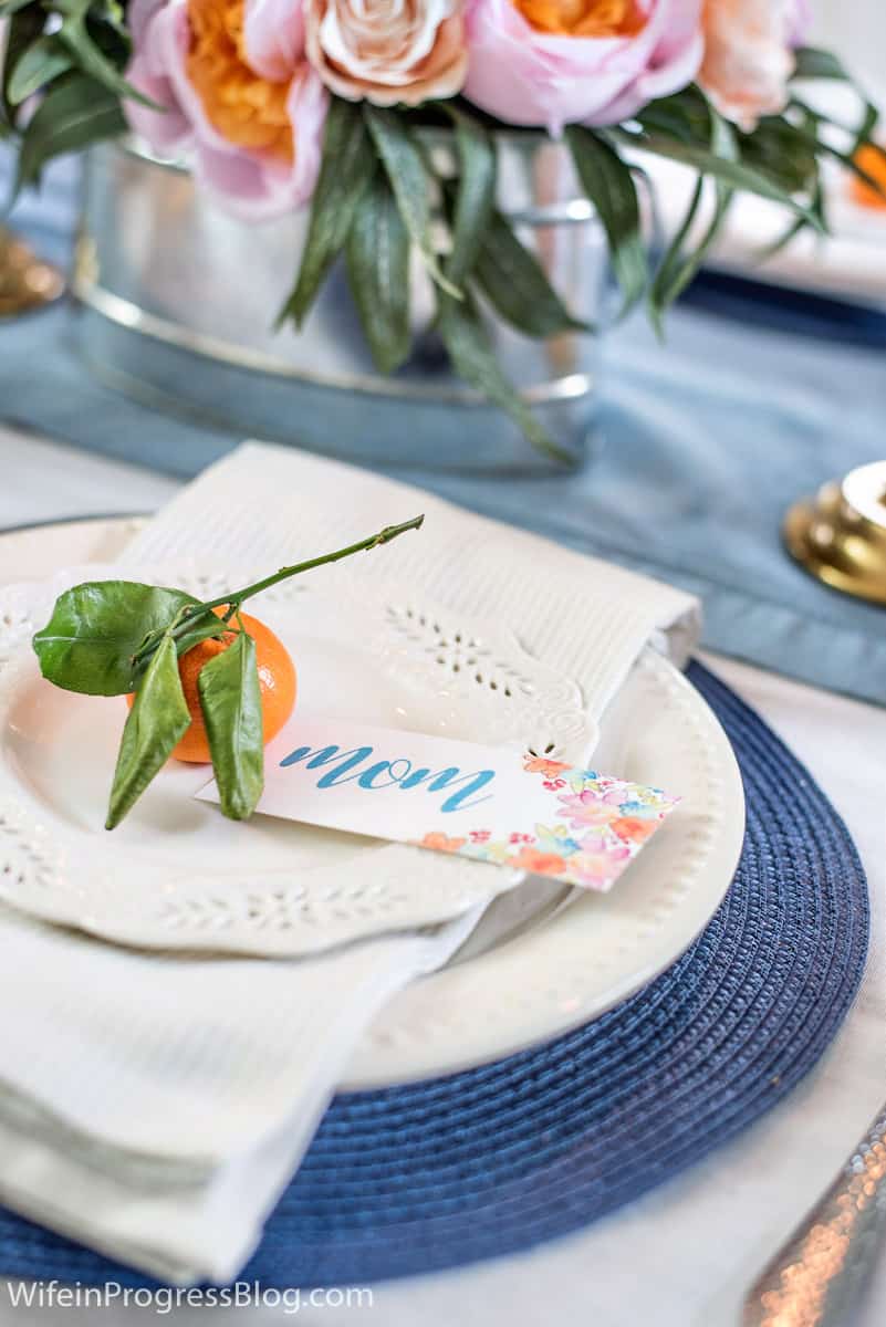 Mother's day tablescape and place setting with stemmed orange and handmade place card