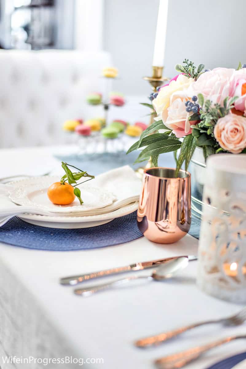 Mother's Day table decor with pink florals, oranges, rose gold wine glasses