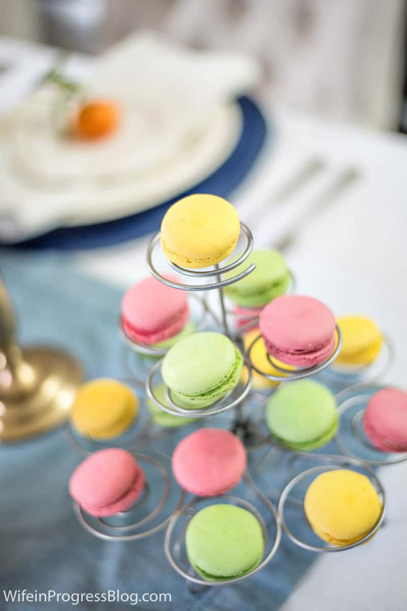 Mother's Day macaroons in yellow, green, and pink on a tiered tray