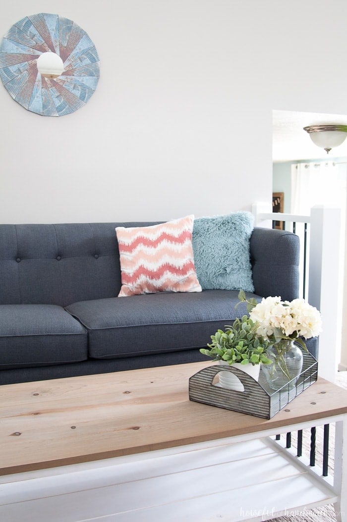 Dark gray living room couch with the wall looking almost gray behind it