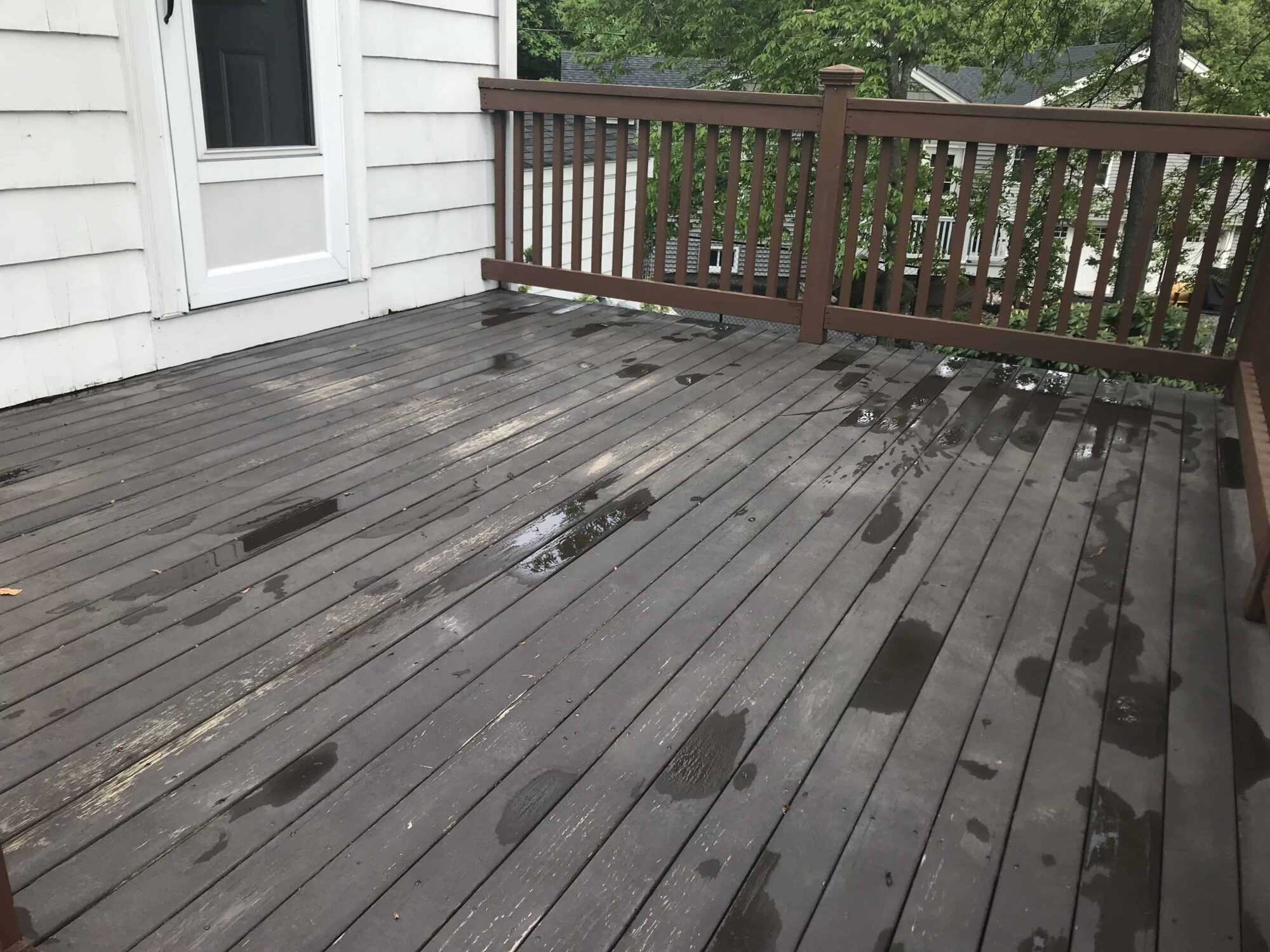 Old deck (emptied of furniture and other items) waiting to be cleaned and prepped for refinishing