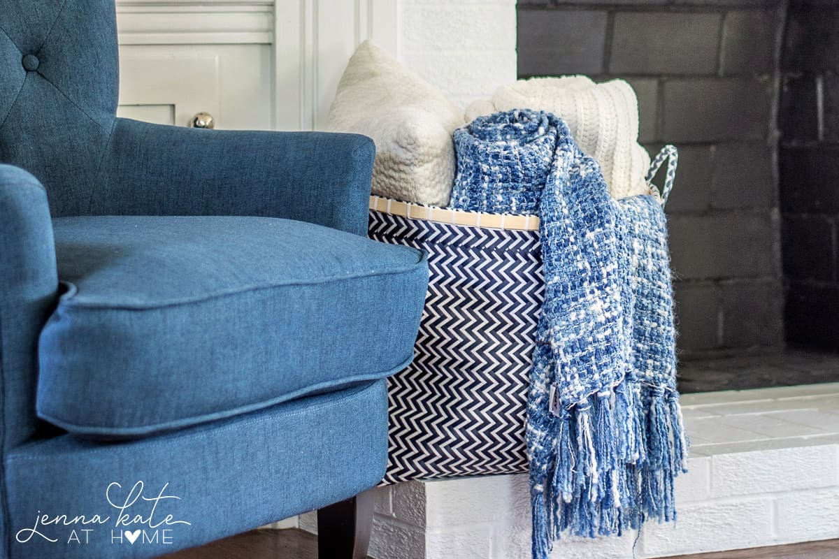 Cozy throws add warmth and texture to this navy blue coastal inspired living room