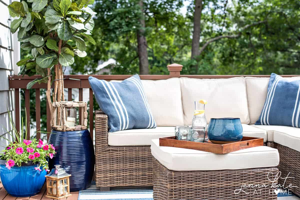small deck with rattan furniture and blue decorative accents