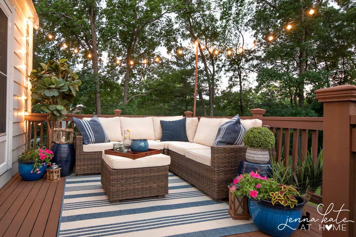 small wood deck with string lights draped around it