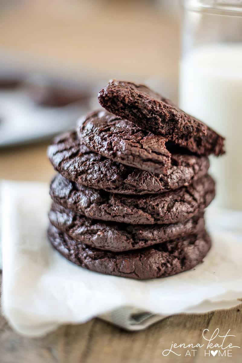 A close up of a stack of chocolate cookies on a napkin