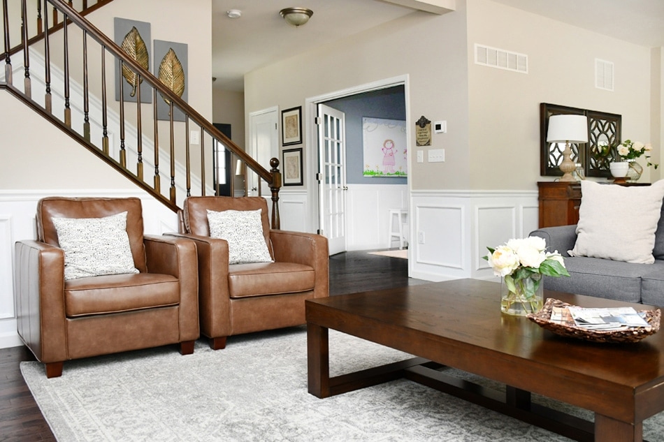 Revere pewter living room walls looking very beige with brown leather furniture and wood accents