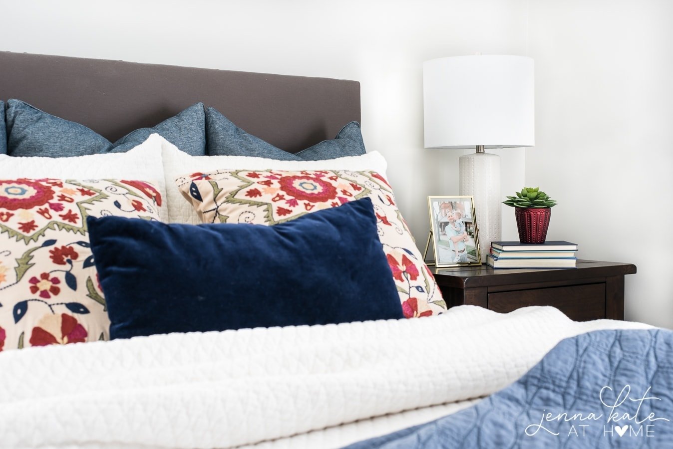 Cozy up your bedroom for fall with floral print pillows on the bed 