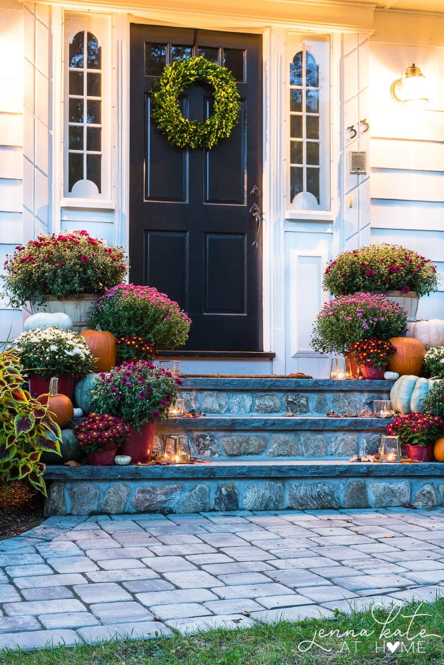 Cute fall porch idea using inexpensive mums, pumpkins and dollar tree buckets as planters