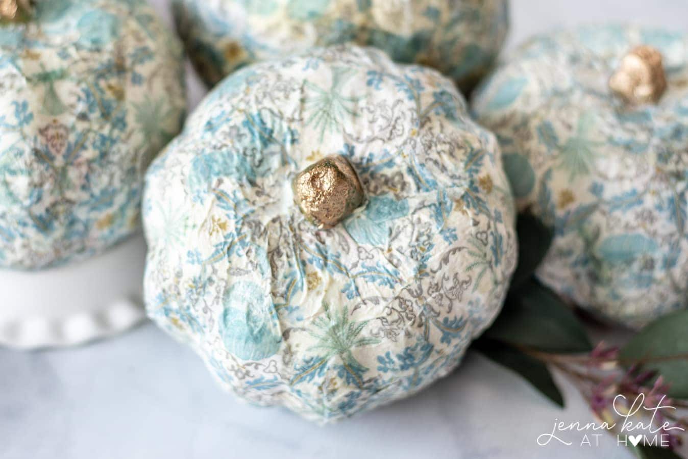 A close up photo of a completed mod podge pumpkin drying.