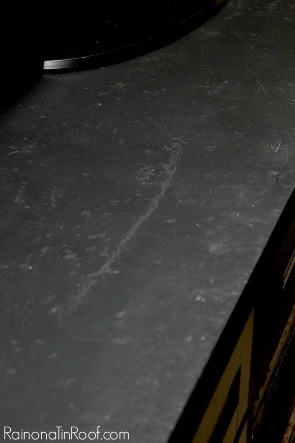 Distressed countertops painted with black chalkboard paint and sealed for a stone look