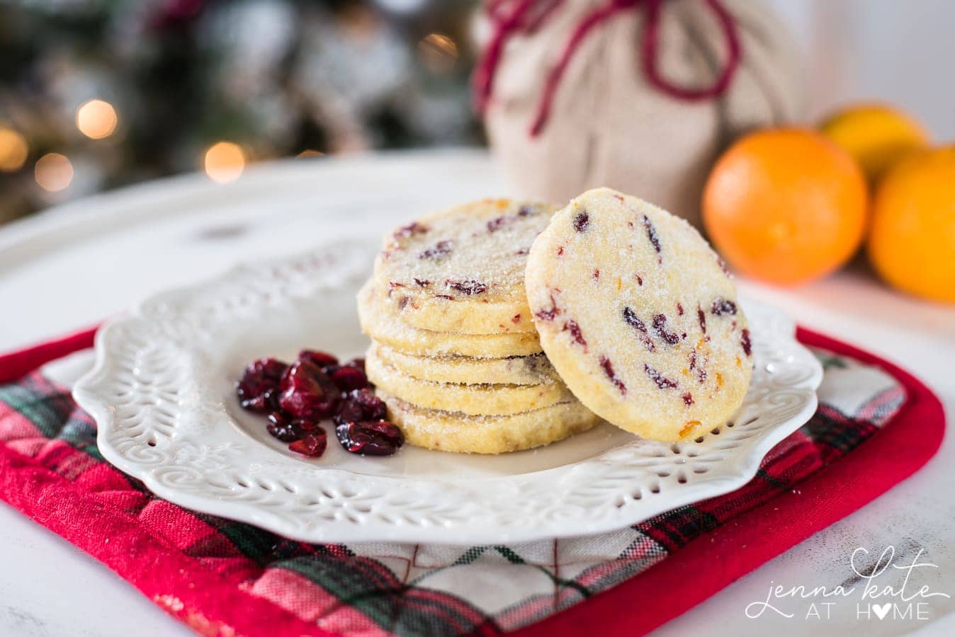 stack of cranberry orange shortbread cookies on a plate