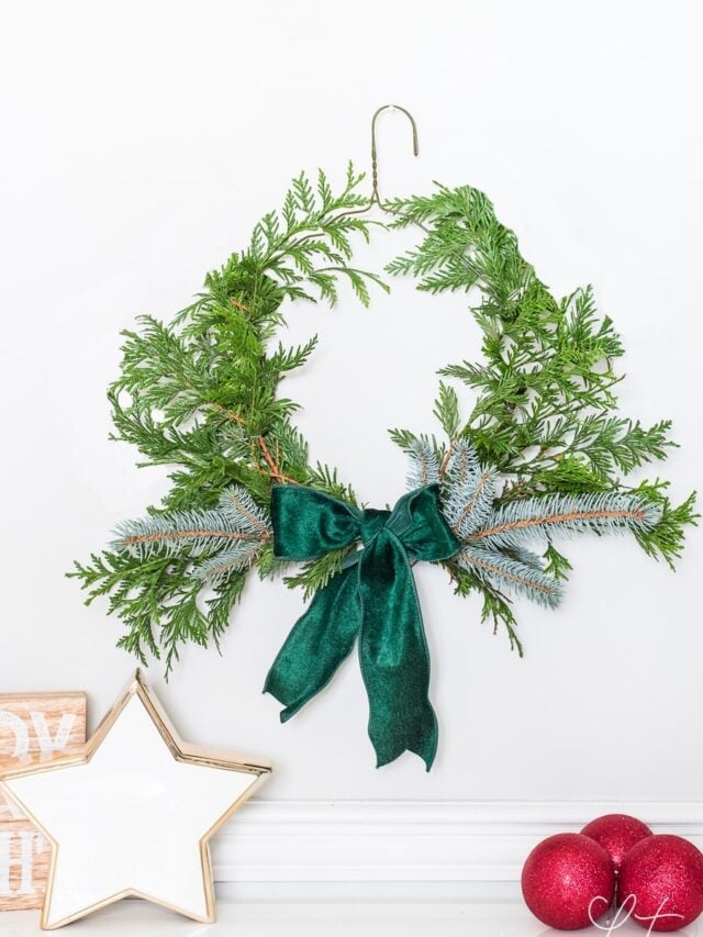 DIY evergreen Christmas wreath using a dry cleaning wire hanger.