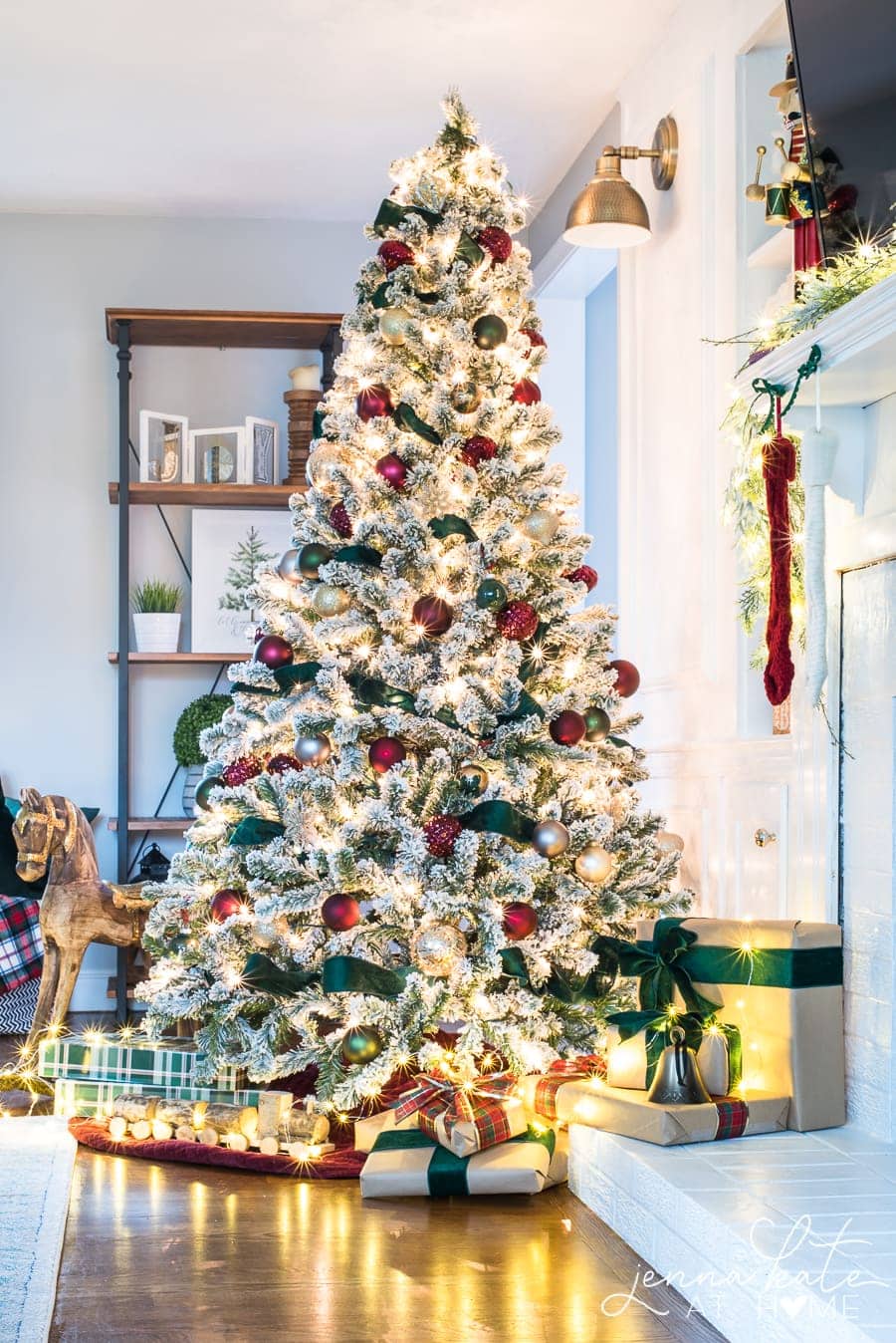 A Christmas tree with clear lights, burgundy ornaments and deep green ribbon