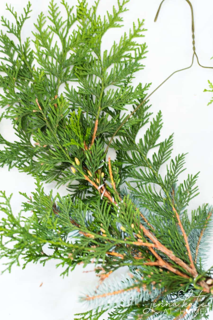 Use a wire hanger to make a DIY evergreen Christmas wreath