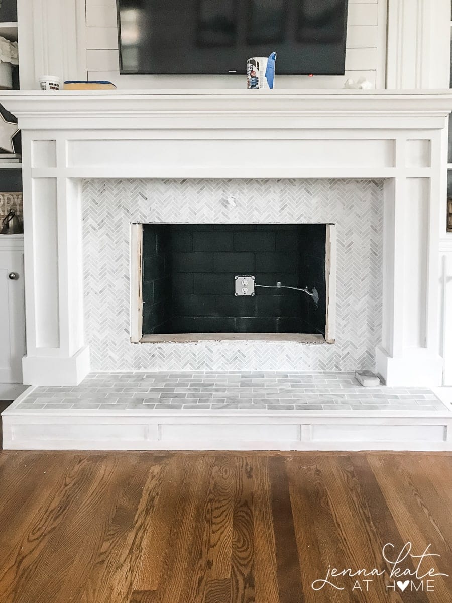Simple wooden fireplace surround with DIY marble tile hearth