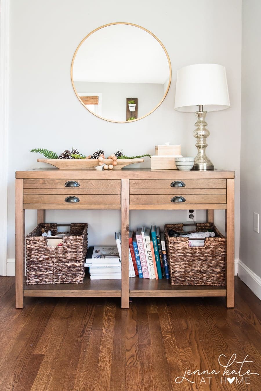 dark wood floors and gray walls with a console table