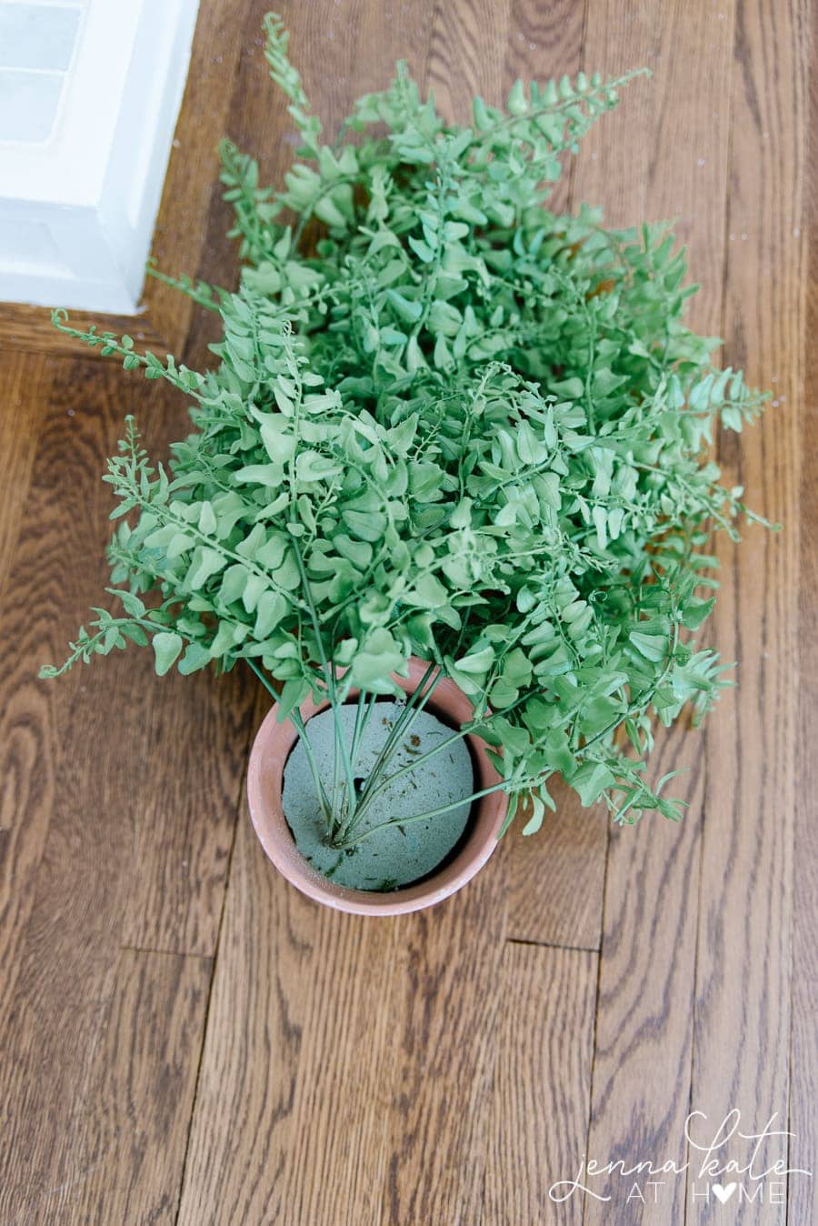 Use floral foam in a classic terra cotta pot to anchor your faux trailing plant
