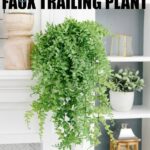 DIY Faux Trailing Plant - a full, green plant resting on the end of a fireplace mantle, with vines trailing down