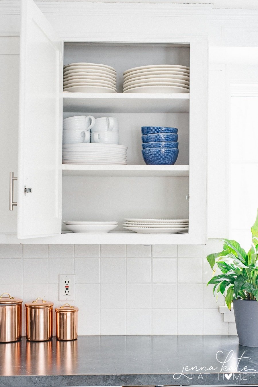 plates and bowls neatly stacked inside cabinet