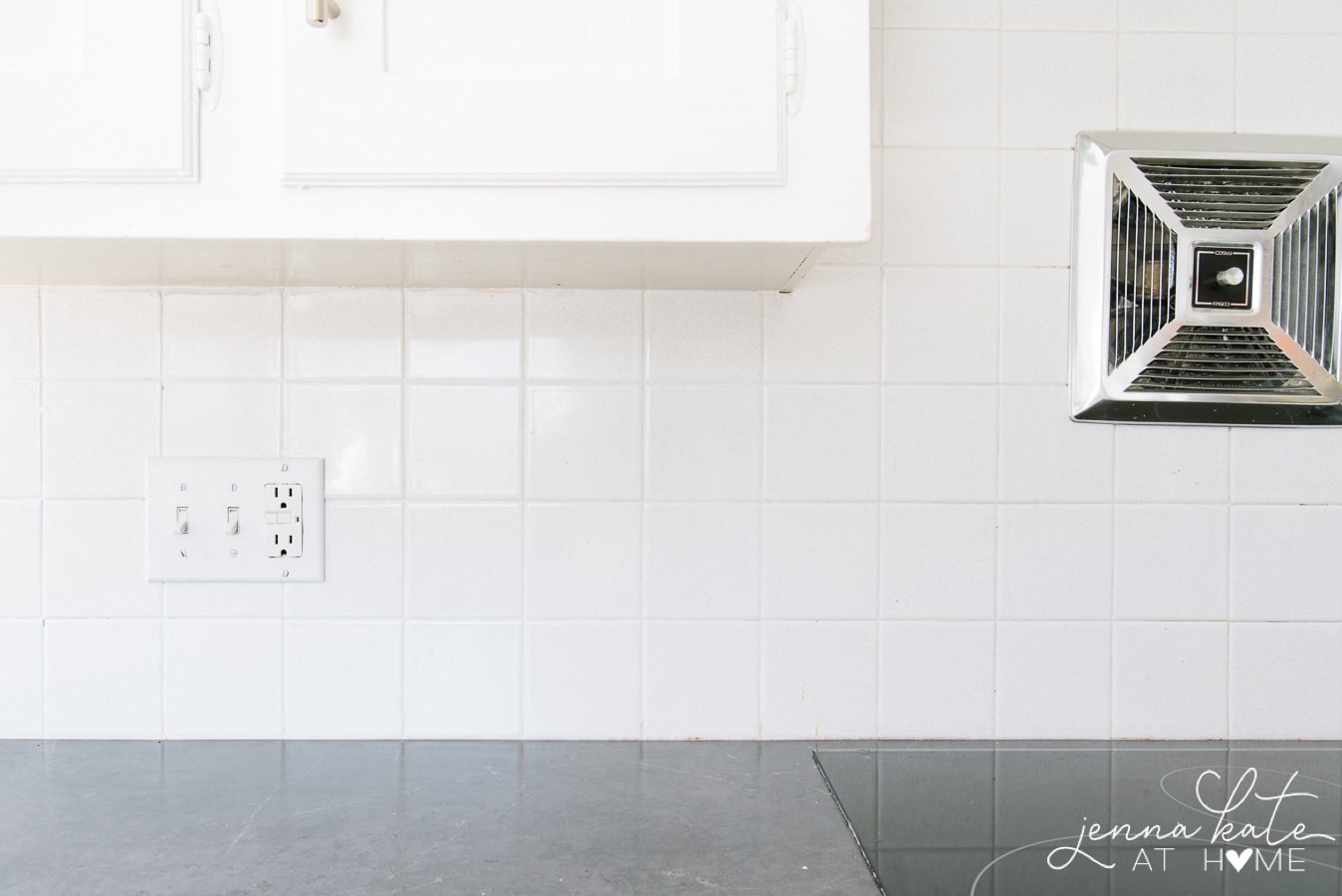 Square, white tile backsplash of a kitchen