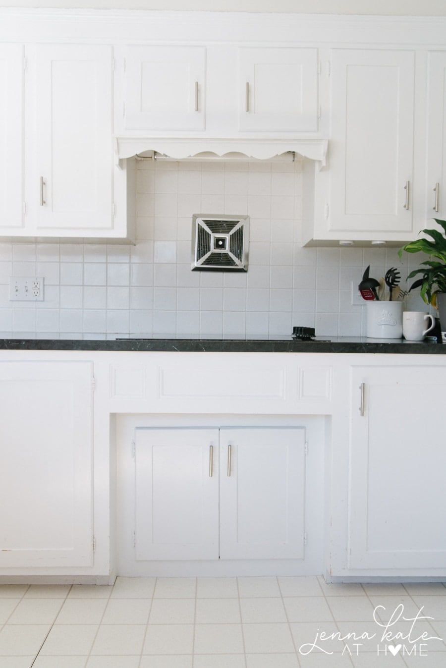 outdated kitchen with scalloped trim over the stove