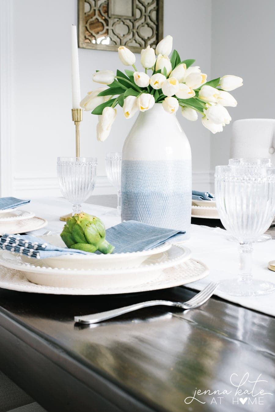 Table setting with a vase full of white tulips